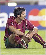 Luis Figo sits dejected on the pitch