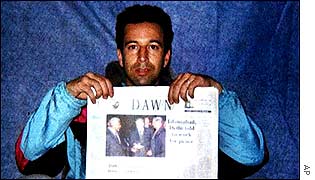 Daniel Pearl holding up newspaper