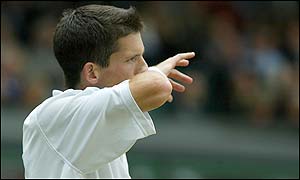 Tim Henman wipes his face as his Wimbledon dream ends against an inspired Lleyton Hewitt