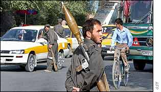 An Afghan security officer with a grenade launcher