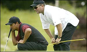 Michael Campbell lines up a shot with the aid of his caddie on his way to ending the day on seven under for the lead
