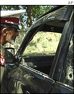 Afghan police guard the assassinated minister's car