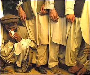 A mourner weeps at the graveside