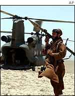 Afghan fighter guards US helicopter at Kakarak, southern Afghanistan