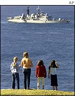 Children stand on Lord Howe Island to view the British warship HMS Nottingham 