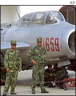 Chinese military personnel with jet aircraft at base outside Beijing