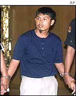 Handcuffed terror suspect Hussain Ramos is presented to the media 