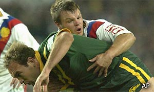 Gorden Tallis of the Kangaroos is tackled by Keiron Cunningham of the Lions 