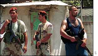Palestinians guard the Ain al-Helweh camp