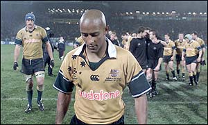 George Gregan eads his defeated side from the pitch