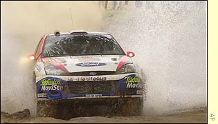 Britain's Colin McRae manages to tame the conditions to take the lead after Saturday's stage