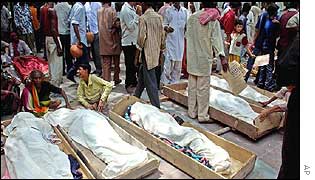Mourning relatives of people killed in the attack in Qasim Nagar
