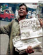 Pakistani newspaper vendor with Pearl special edition