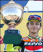 Valentino Rossi of Italy holds the trophy after winning the British Grand Prix at Donington Park