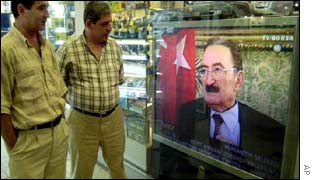Customers in a Turkish electronics shop watch Prime Minister Bulent Ecevit on TV