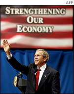 US President George W. Bush waves to the crowd at the Alys Stephens Center after speaking about the current economy at the University of Alabama in Birmingham