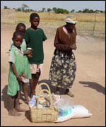 A grandmother and her grandchildren receive a Red Cross food basket (Pic: Red Cross )