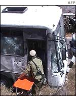 Soldier carries stretcher on to the bus