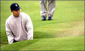 Tiger plays out of a bunker at the 14th during his practise round