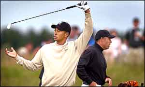 Tiger Woods stretches during his practice round