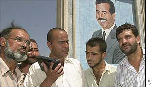 Iraqis listen to speech by radio