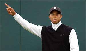 Tiger Woods reacts after slicing his tee shot