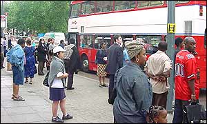 Commuters wait at the bus stop