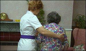 A nurse takes care of an elderly lady