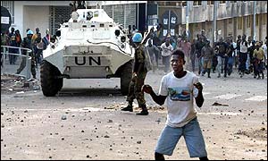 UN vehicle and rioters during May election campaign