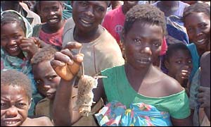 Woman holds a rat in Angola