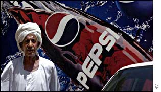 A Sudanese man in front of a Pepsi hoarding in Khartoum