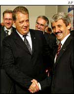 Latvian Prime Minister Andris Berzins (left)