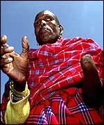 A Kenyan amputee stands outside the Houses of Parliament in London