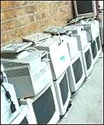 monitors and keyboards piled up