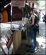 Belgrade teens shopping at a kiosk for pirate CDs