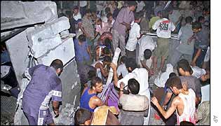 Palestinians search the remains of Shahada's house