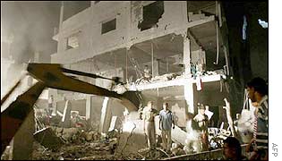 Palestinians search in the ruins of a building hit by an Israeli jet strike 