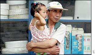A man holds a young girl in Beijing