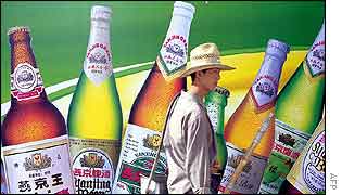 A man walks past an advertising hoarding in Beijing