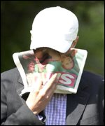 David Norris covers his face as he arrives at court on Wednesday