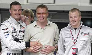 David Coulthard teases Mika Hakkinen at the Monaco Grand Prix about the amount of weight he has put on while away from F1, as Kimi Raikkonen looks on