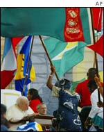 Young Catholics wave brightly coloured flags