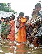 Bangladeshi children brave floods to go to school