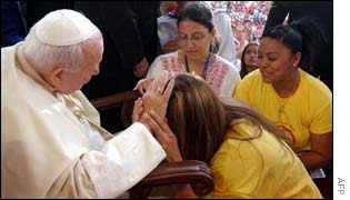 The Pope blesses a young worshipper