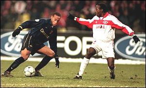 Thierry Henry takes on Jerry-Christian Tchuisse in the Champions League