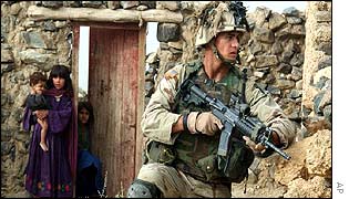 Afghan children hide as US soldier hunts for al-Qaeda forces in Afghanistan