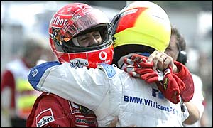 Michael and Ralf Schumacher embrace after securing first and second place on the grid respectively for Sunday's German Grand Prix