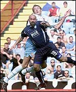 Aston Villa's Peter Crouch climbs to win a header