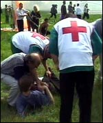 Aid workers help the injured, some of them in a critical condition