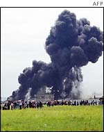 Smoke above crowds of people at the crash